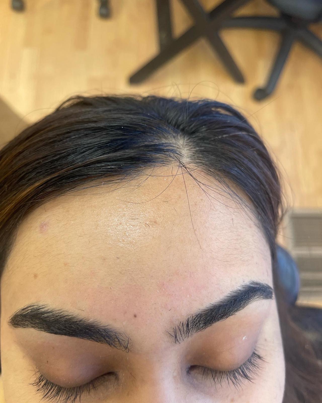 Sharp, symmetrical eyebrows after threading and tinting at Queen Salon & Beauty