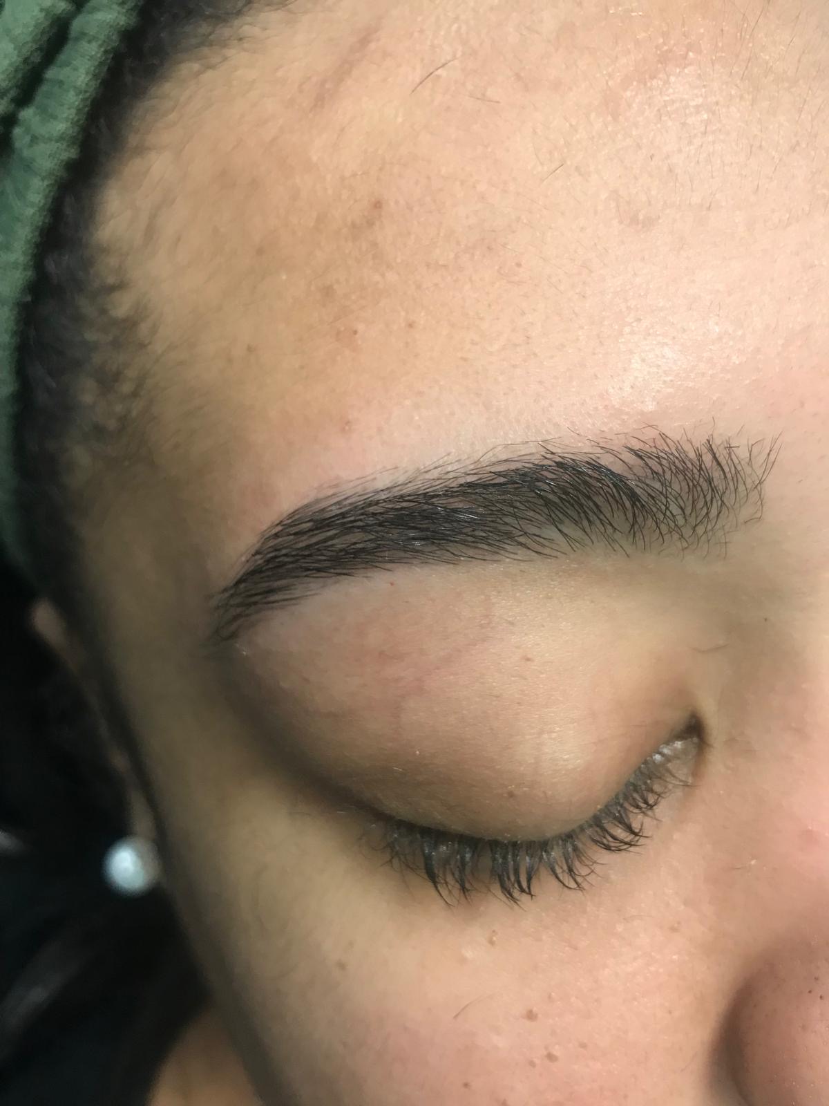 Neatly threaded eyebrow with clean edges and natural fullness