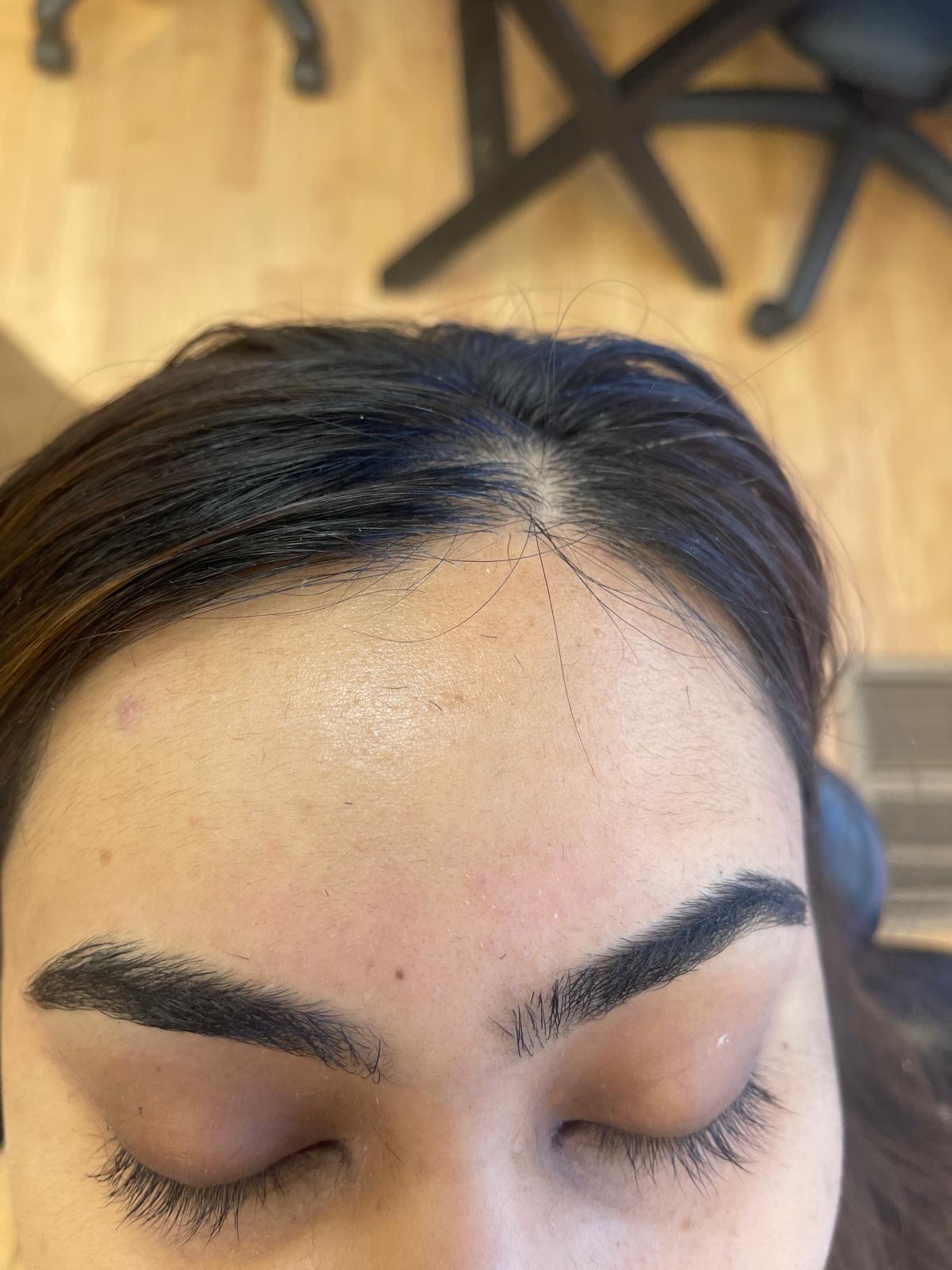 Symmetrical eyebrows shaped and tinted for a defined finish
