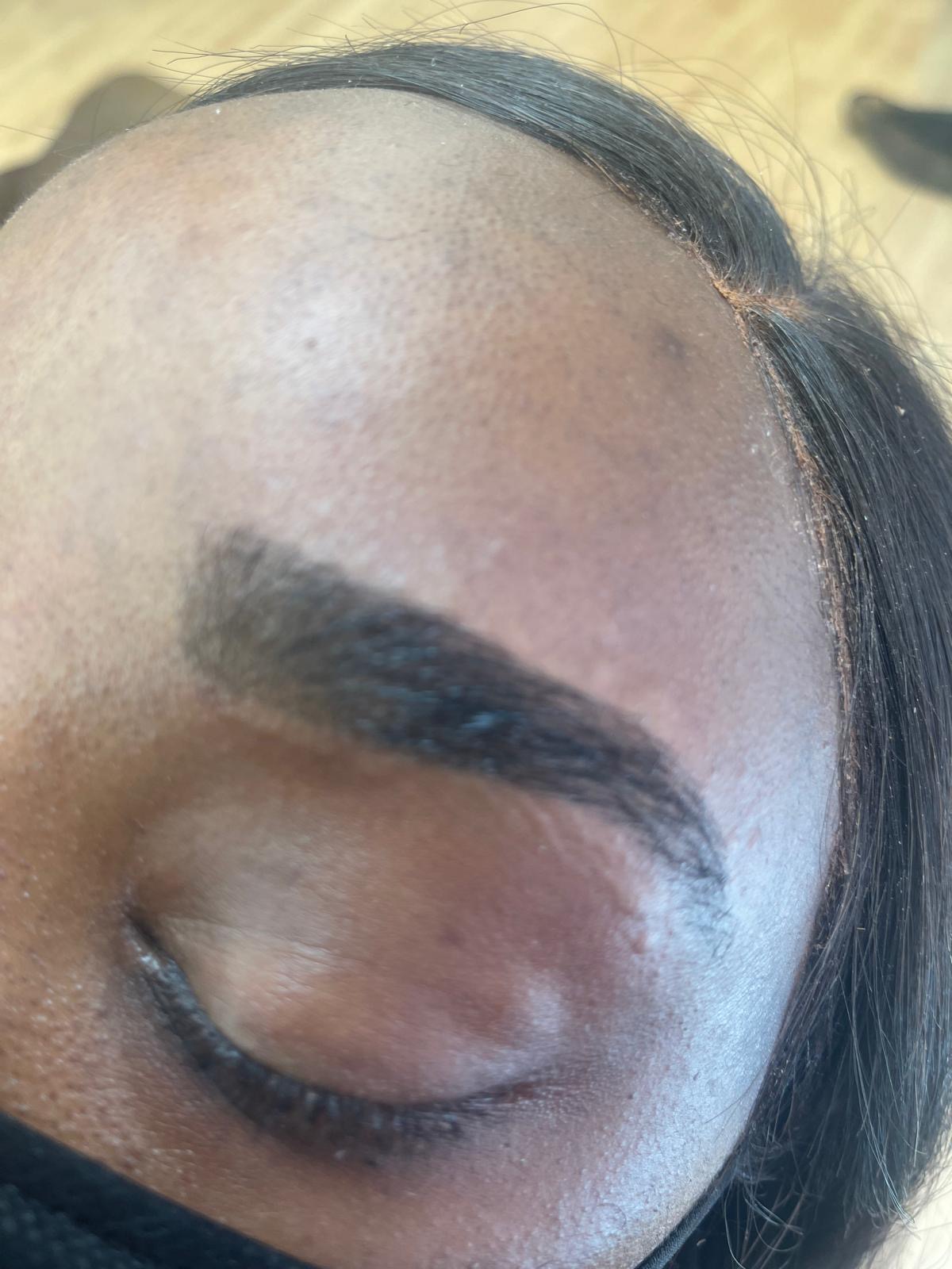 Bold tinted eyebrow with a crisp arch and tapered tail