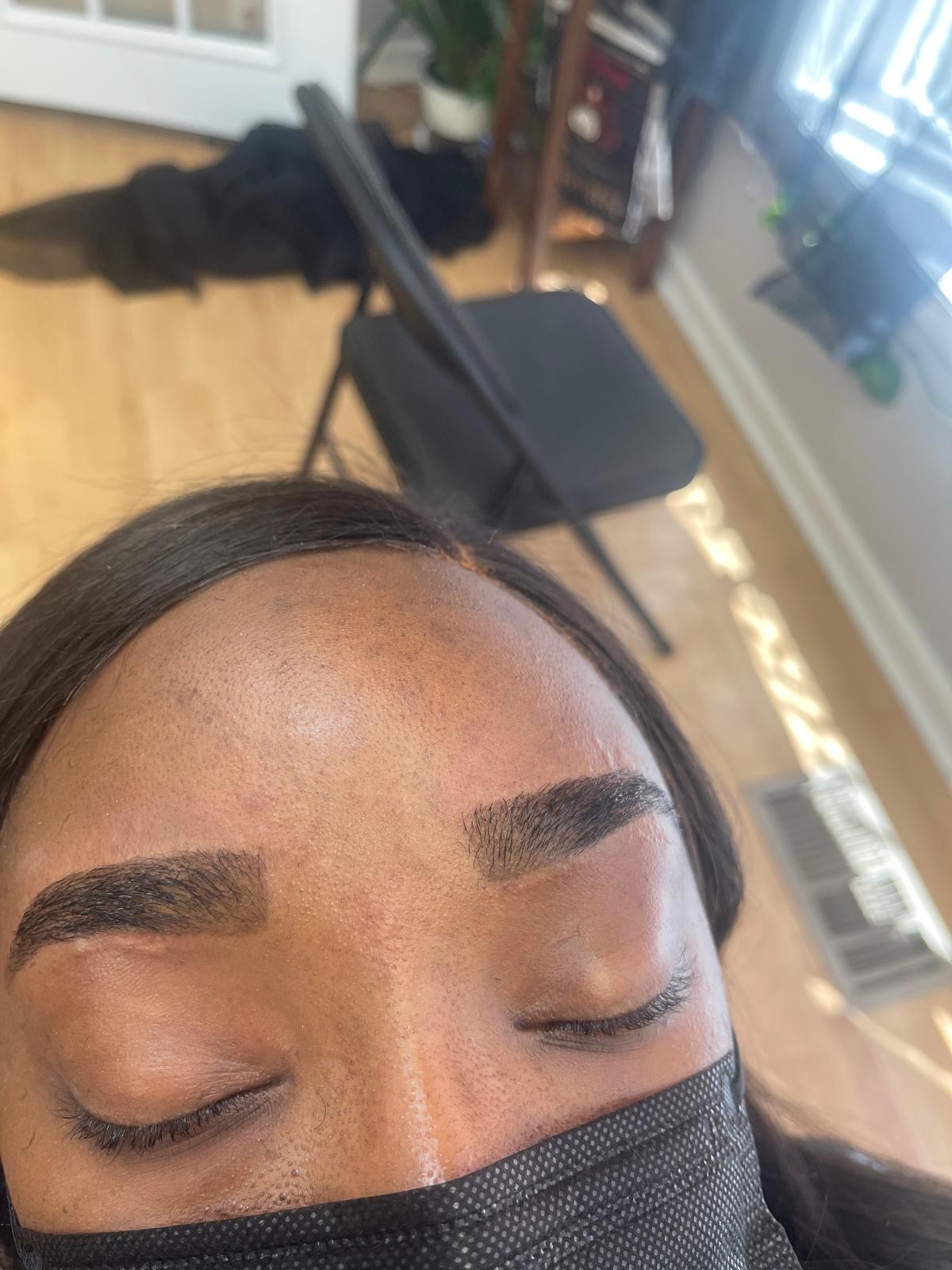 Balanced pair of eyebrows shaped and tinted in the salon