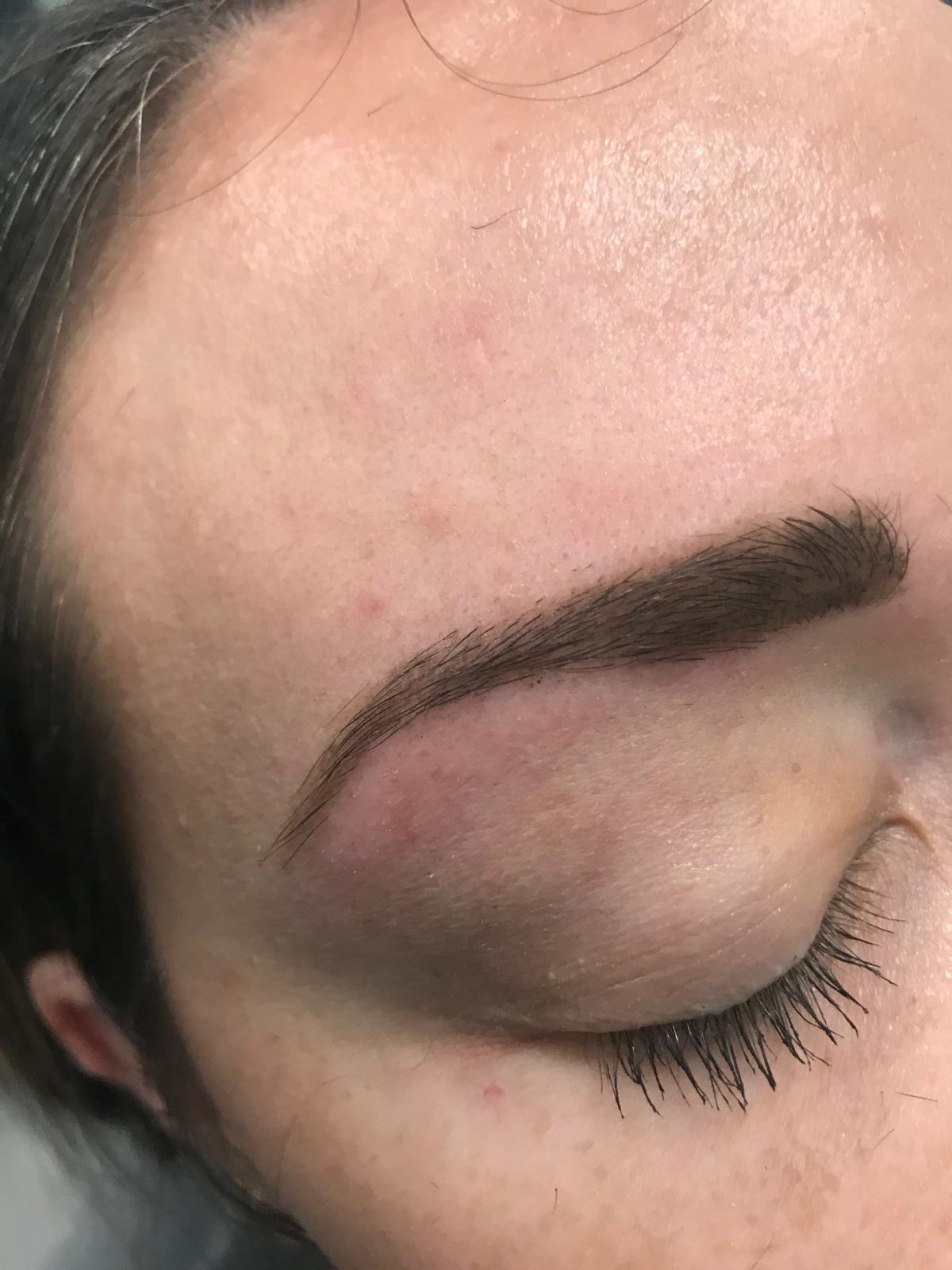 Close-up of a shaped eyebrow with softly curled lashes