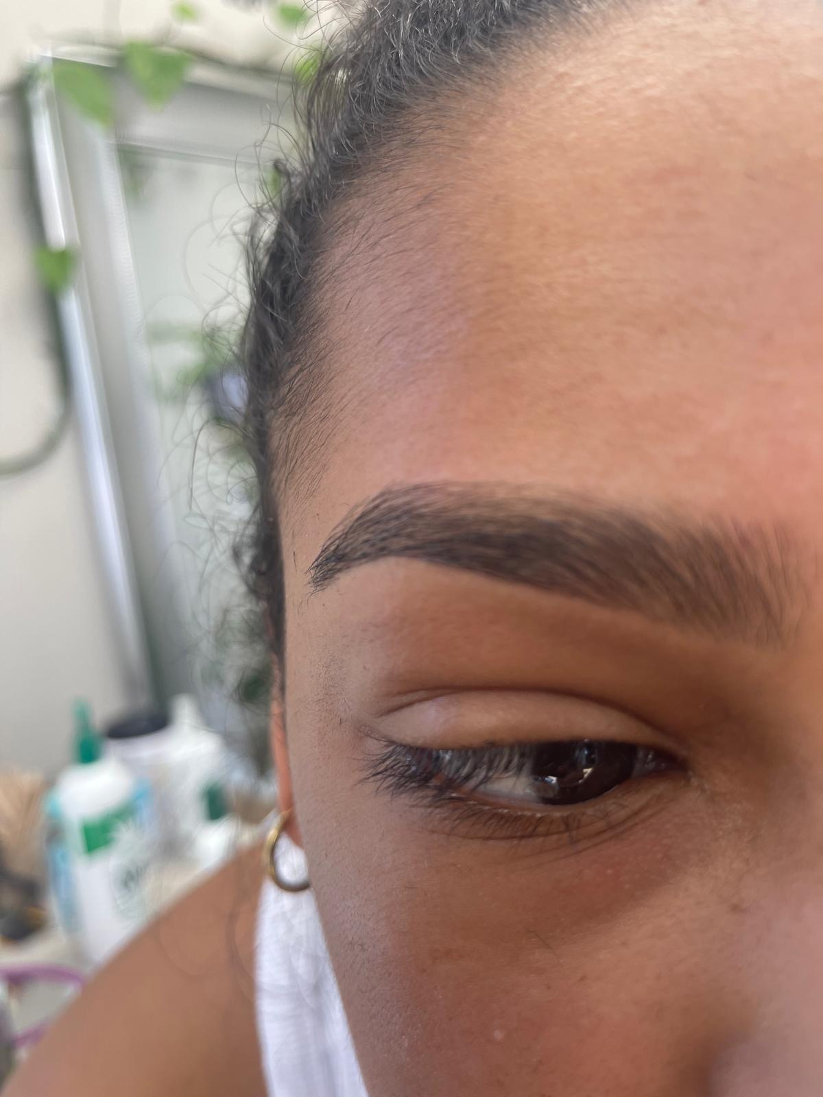 Freshly threaded eyebrow with a soft arch and tinted lashes at Queen Salon & Beauty in Nashville